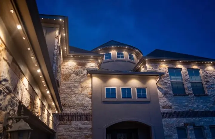 Warm white permanent accent lighting on a Calgary home exterior